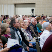 an audience watches Mike and Robert on stage