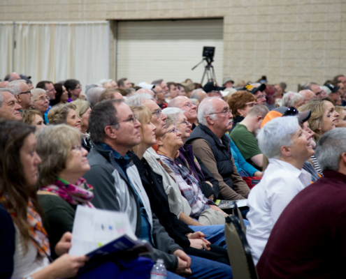 an audience watches Mike and Robert on stage