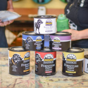 Cans of Black Dog Salvage's furniture paint and top coat line