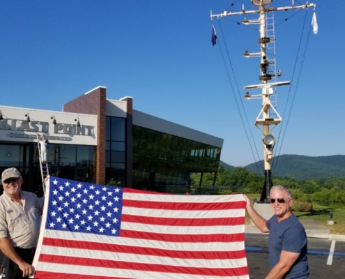 a larger American flag outside of Ballast Point Brewing Company