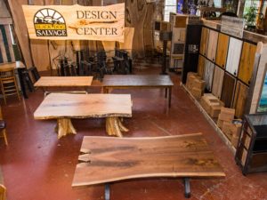 tables made from salvaged wood below a Design Center sign