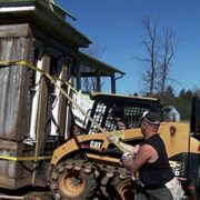 a bobcat is used to salvage the Izard House